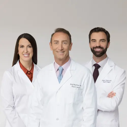1-philosophy Three doctors in white coats stand together, smiling at the camera.